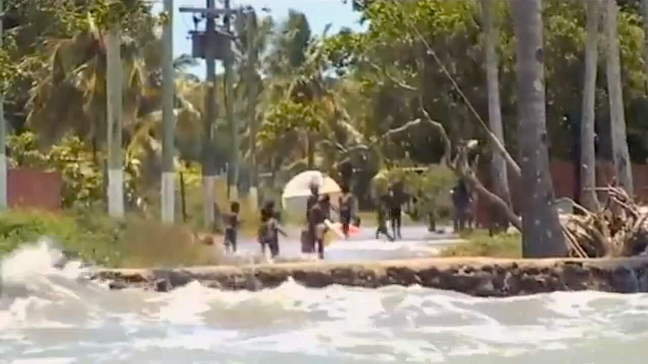 A king tide threatens to surge over an old seawall in Saibai, Torres Strait.