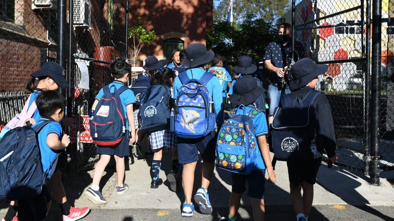Students arrive to Carlton Gardens Primary school in Melbourne, Thursday, February 18, 2021. Victoria has recorded no new locally acquired coronavirus cases as life returns to COVID-normal after the state's five-day "circuit breaker" lockdown. (AAP Image/