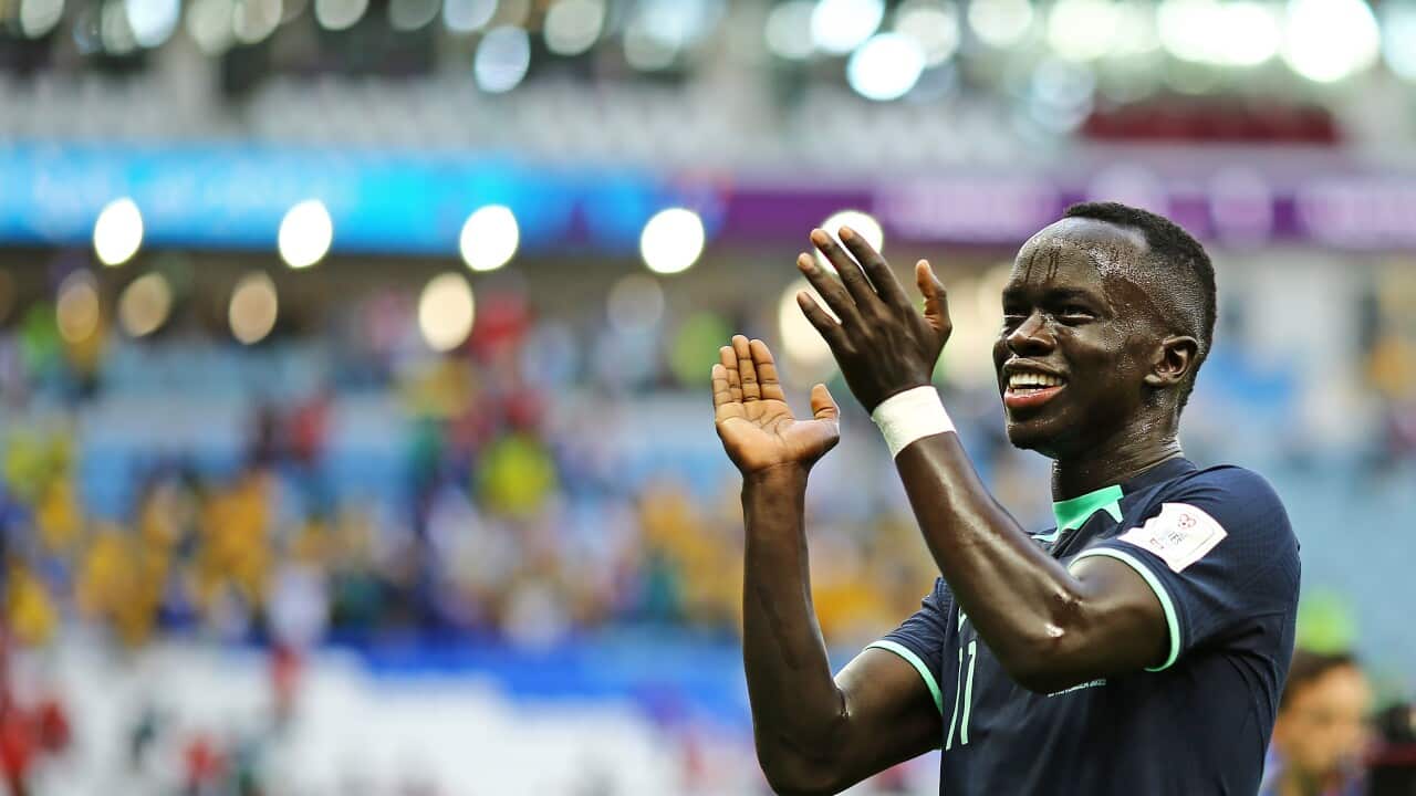 A football player claps during a match.
