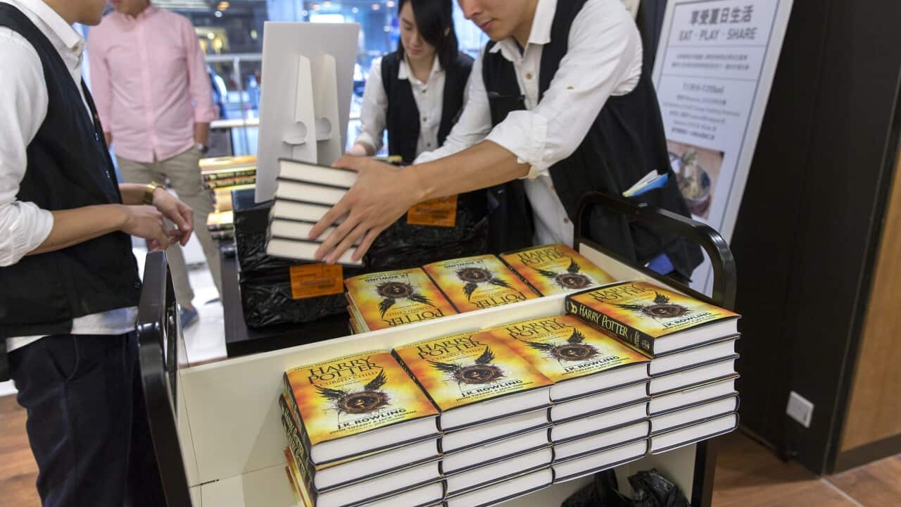 Staff unpack copies of J.K. Rowling's 'Harry Potter and the Cursed Child' at a bookstore in Hong Kong.