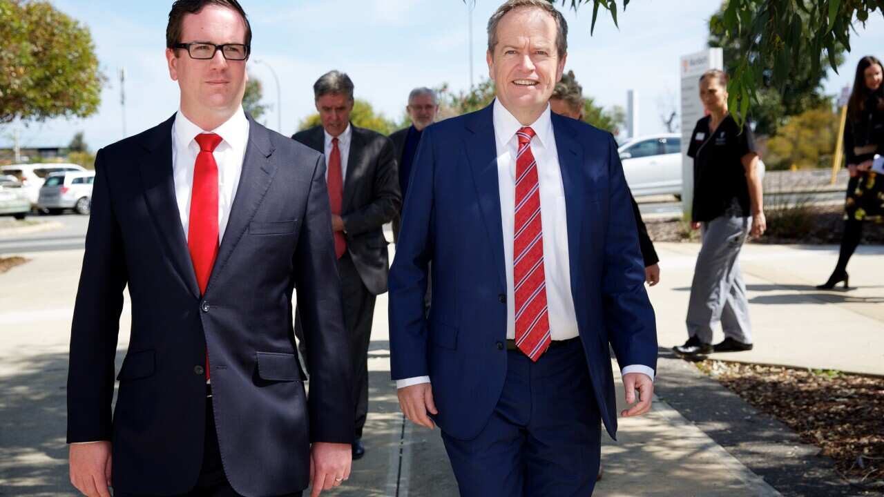 Federal Opposition Leader Bill Shorten walks with Labor candidate for Canning Matt Keogh