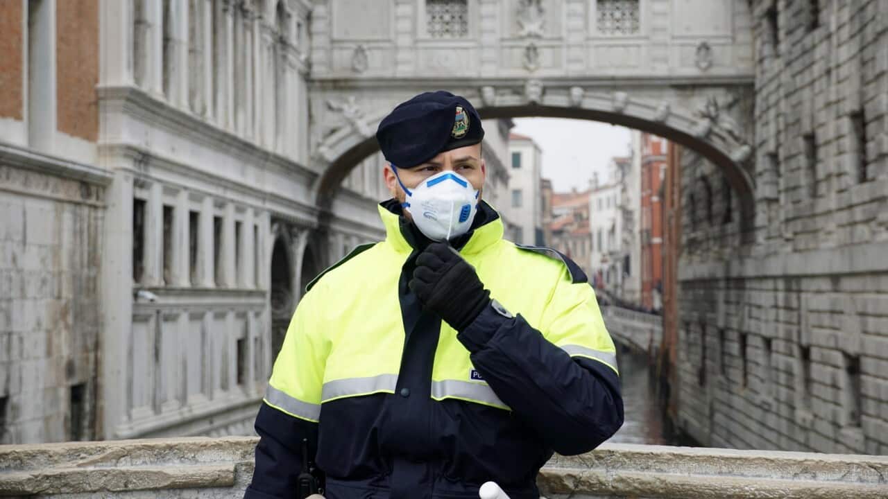A local police officer wears a protective face mask during the Carnival in Venice, Italy, 23 February 2020.