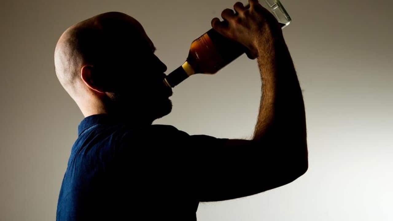 A man drinking alcohol