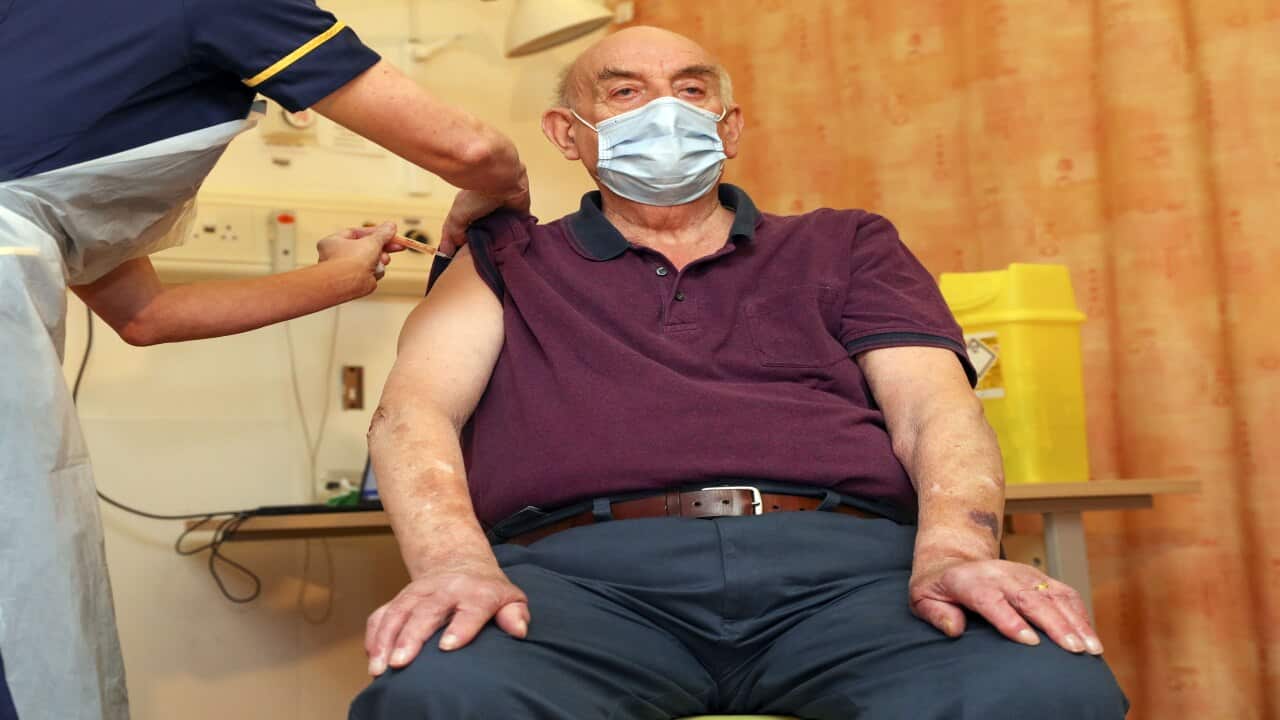 82-year-old Brian Pinker receives the Oxford University/AstraZeneca COVID-19 vaccine from nurse Sam Foster at the Churchill Hospital in Oxford.