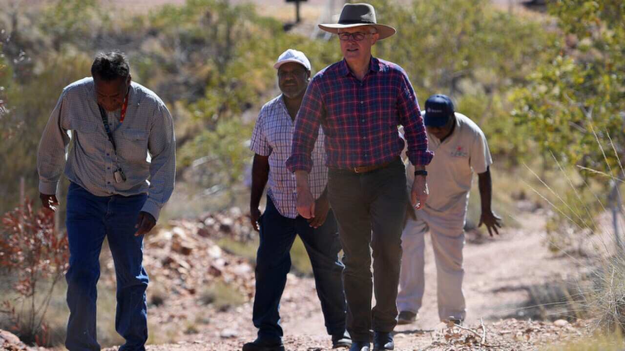Prime Minister Malcolm Turnbull visits the Battery Hill mining museum with tradition owner Ronald Plummer (left) at Tennant Creek.