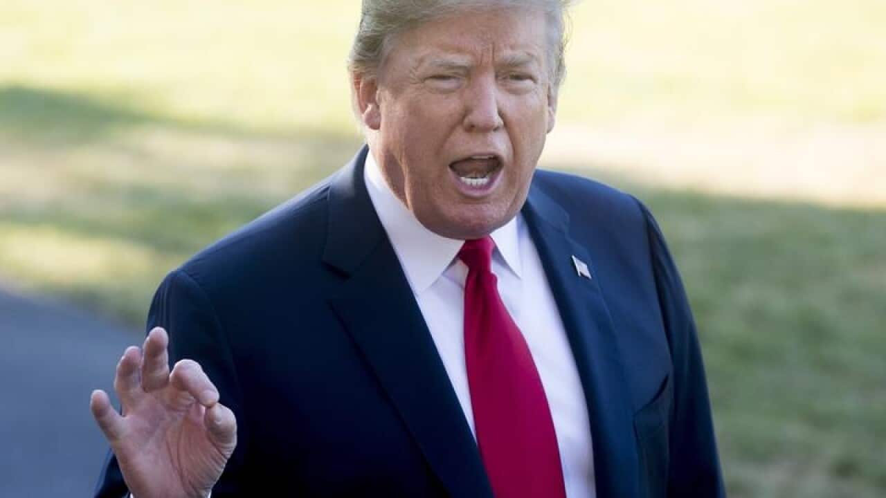 US President Donald Trump speaks to the media outside the White House.