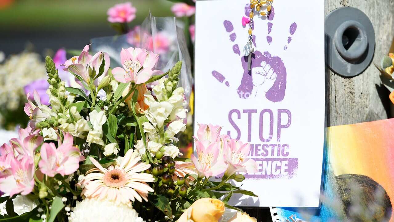 A floral tribute at a domestic violence memorial