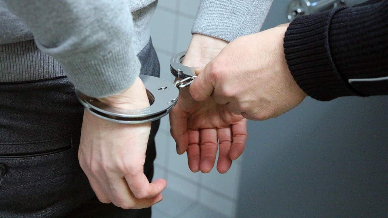 A suspect handcuffed by police