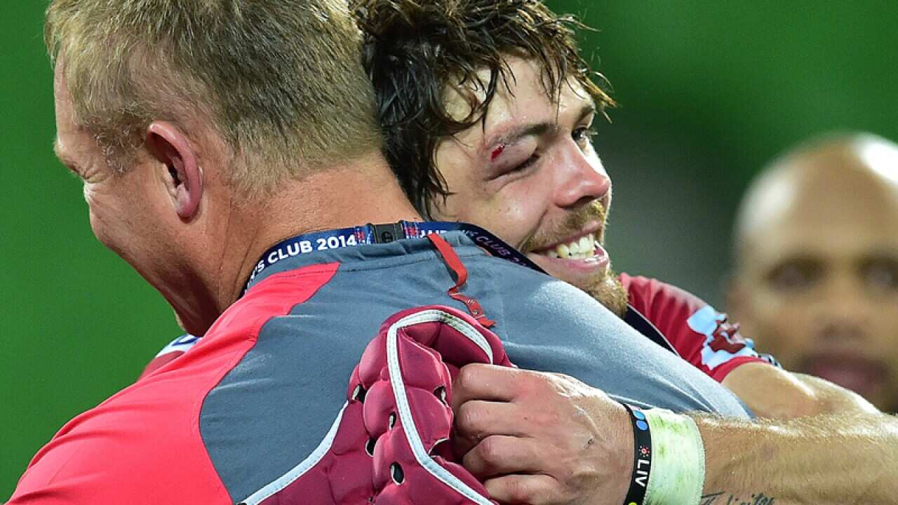 Lions coach Johan Ackermann (left) hugs captain Waren Whiteley