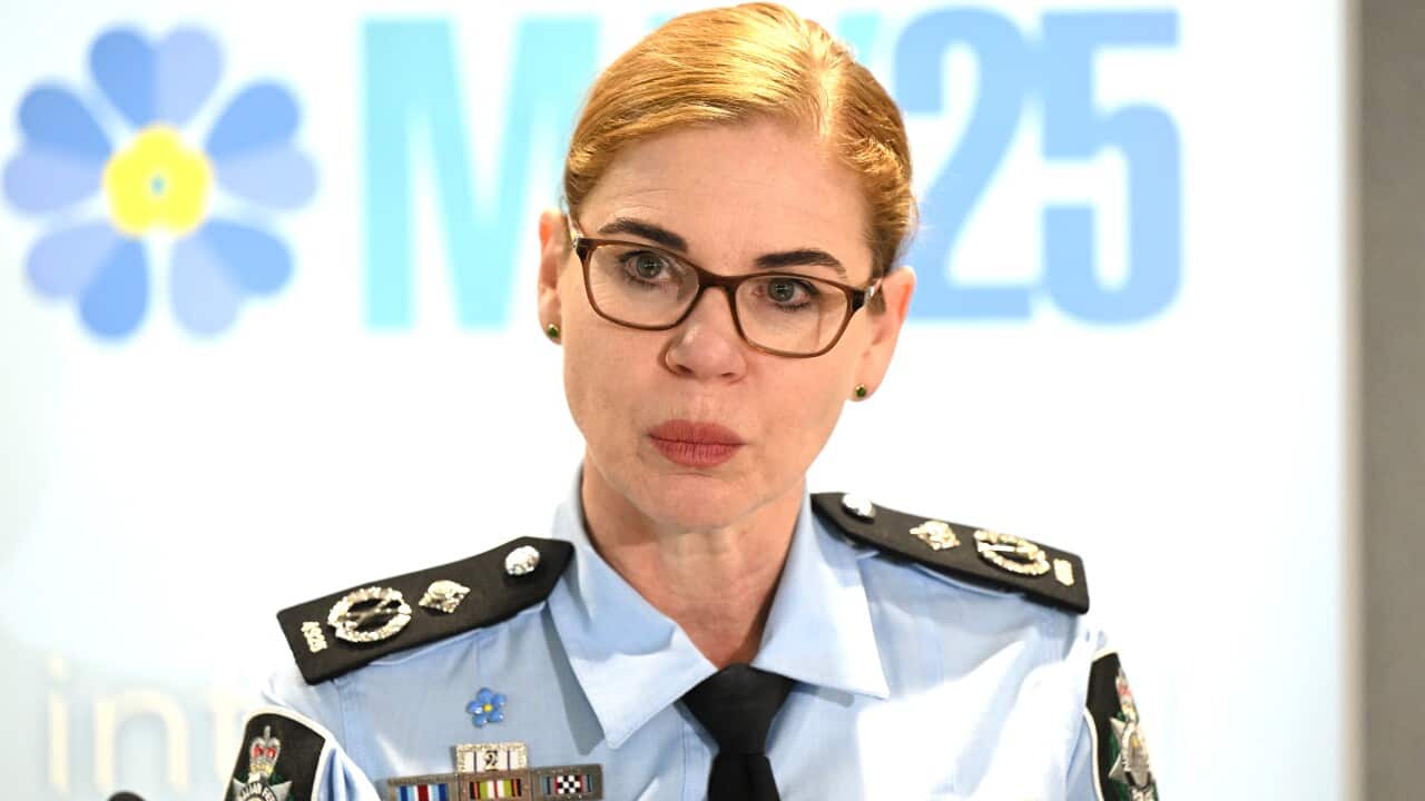 A woman standing at a lectern.