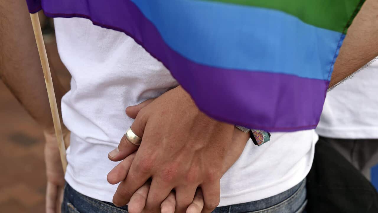 Adam Wadding and his boyfriend Gabriel Smith hold hands during a rally at the John H. Ruffin, Jr., Courthouse in Augusta, Ga., on Friday, June 26, 2015. (Jon-Michael Sullivan/The Augusta Chronicle via AP)