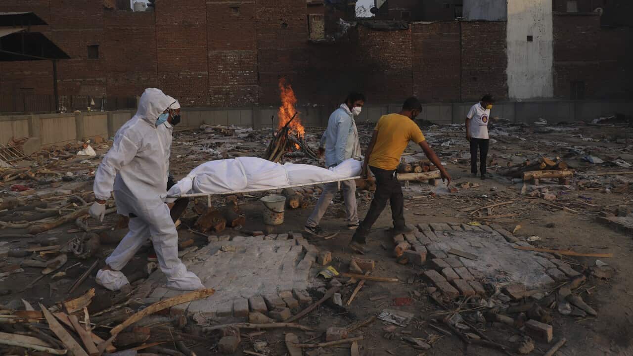 family members and volunteers carry the body of a COVID-19 victim for cremation in New Delhi, India.