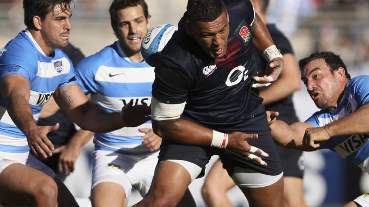 England's Nathan Hughes (C) is tackle by Argentina's Agustin Creevy