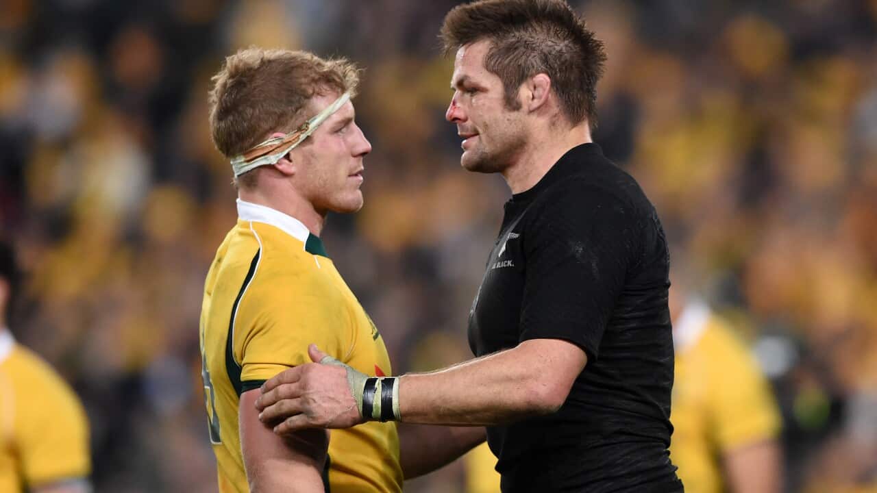 All Blacks captain Richie McCaw (right) congratulates Wallabies player David Pocock following the Rugby Championship and Bledisloe Cup match between Australia and New Zealand at ANZ Stadium in Sydney 2015. (AAP)