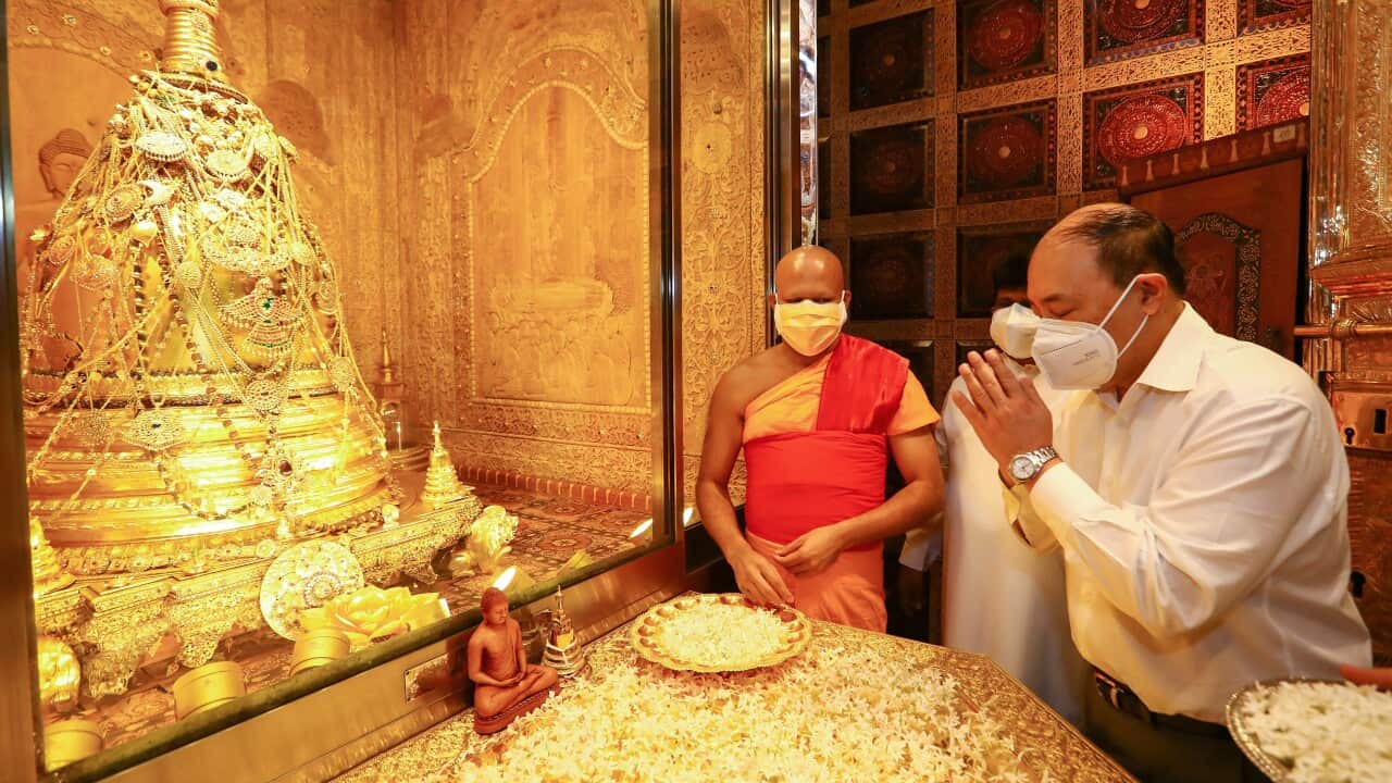 Indias Foreign Secretary Harsh Vardhan Shringla (R) pays respects at the Sri Lankas holiest Buddhist shrine 'Temple of the Tooth' during his official visit in Kandy on October 3, 2021