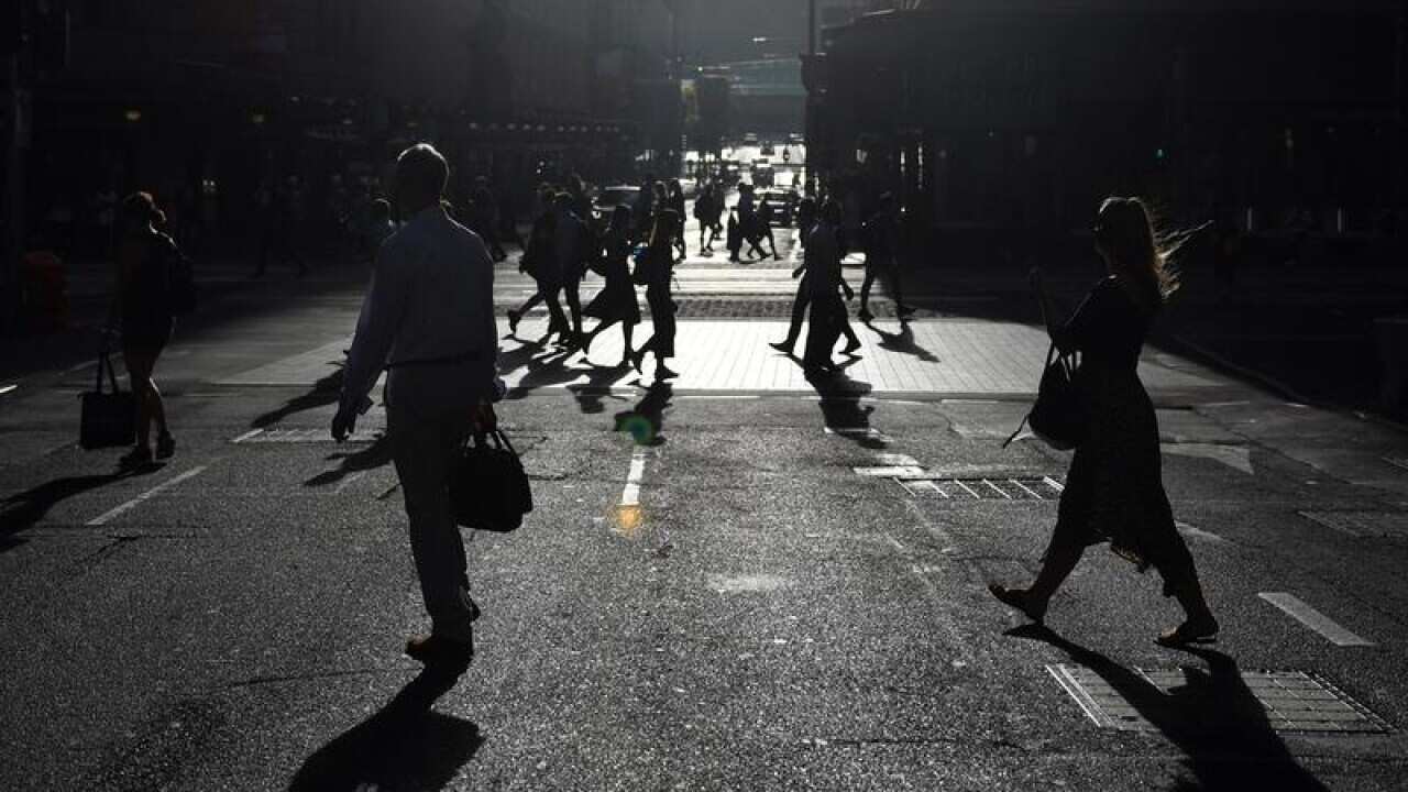 Office workers are seen arriving to work in the Sydney CBD.