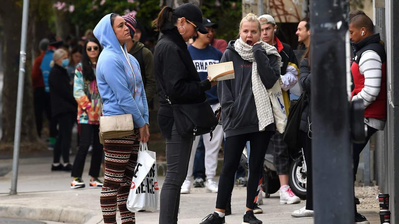People are seen waiting in line at the Prahran Centrelink office in Melbourne.