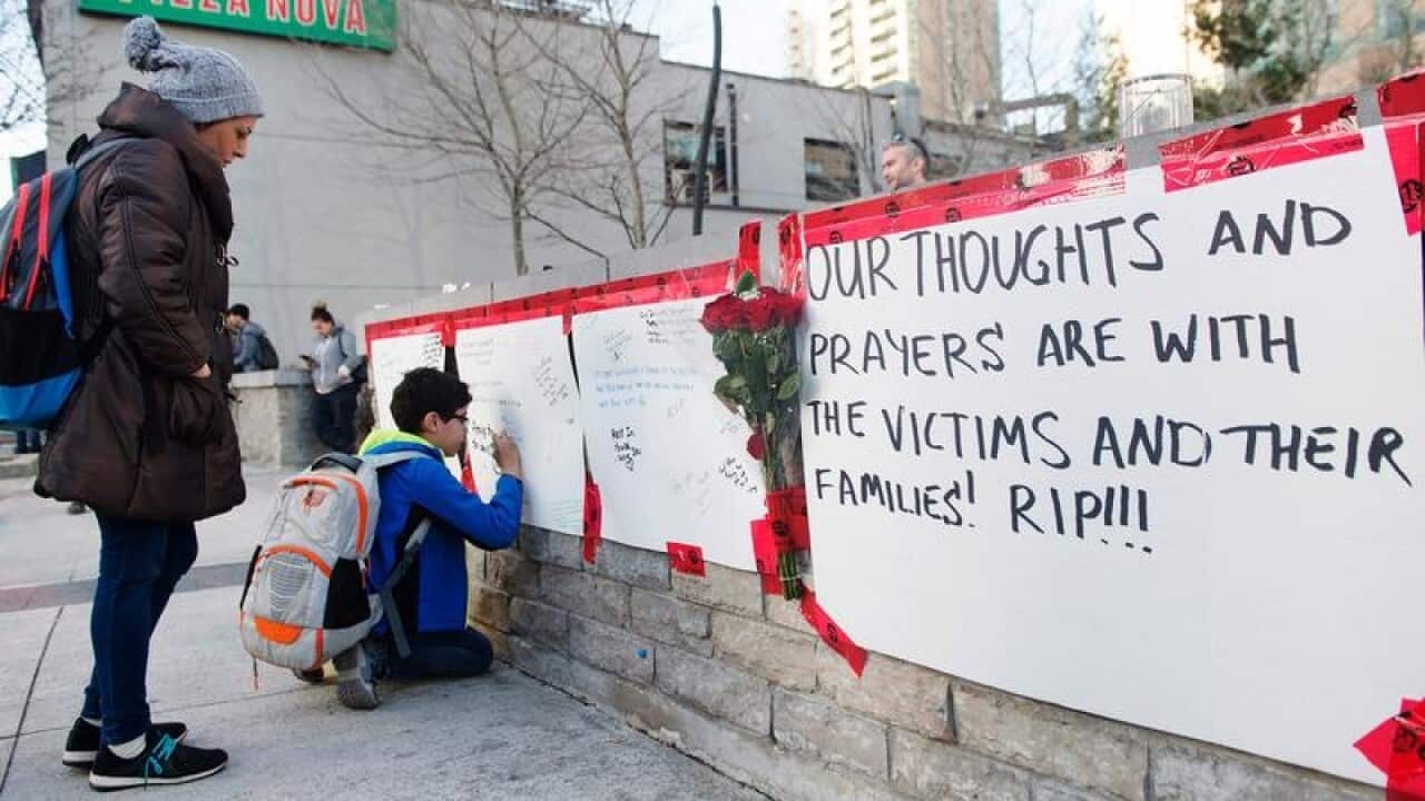 Mourners sign a memorial in Toronto.