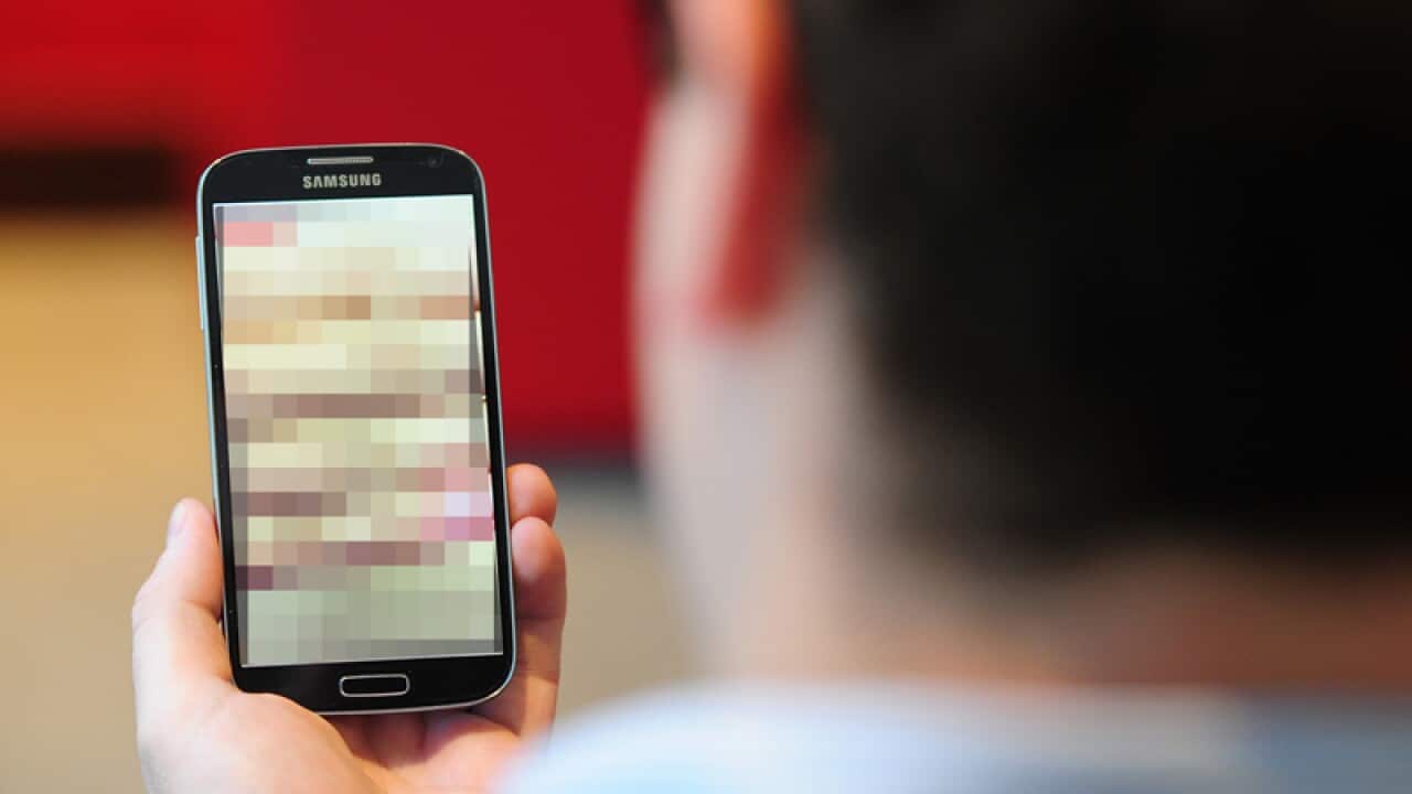 A model looks at a mobile phone