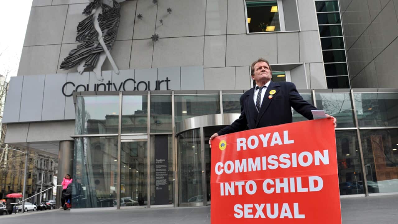 A man demonstrates outside the royal commission into child abuse