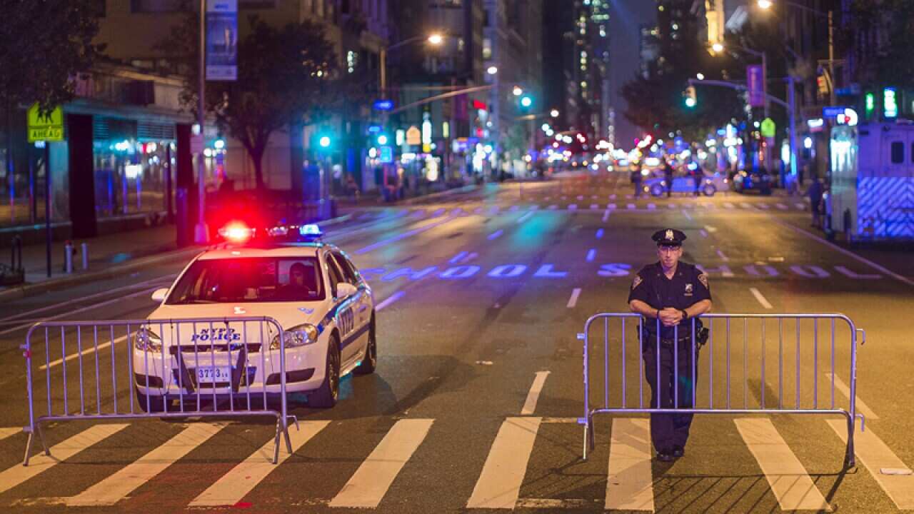 Police stand guard as the cordon Sixth Avenue