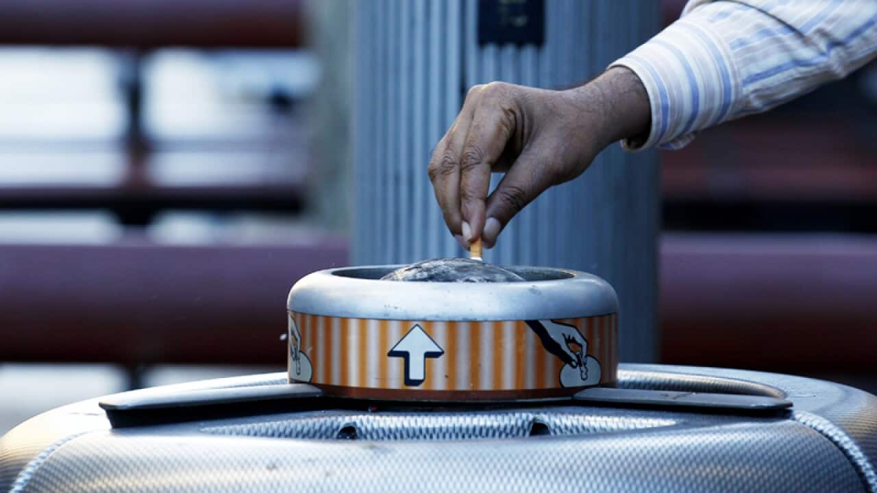 Putting out a cigarette.