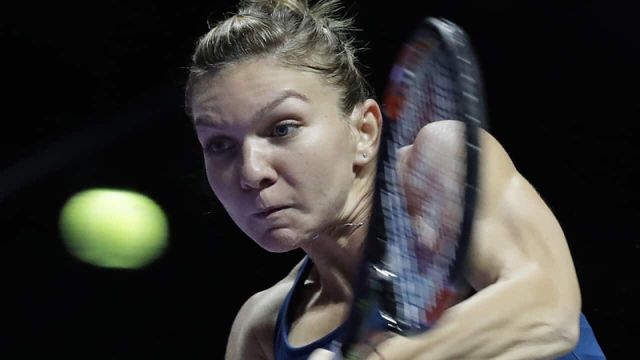 Simona Halep of Romania makes a backhand return against Madison Keys