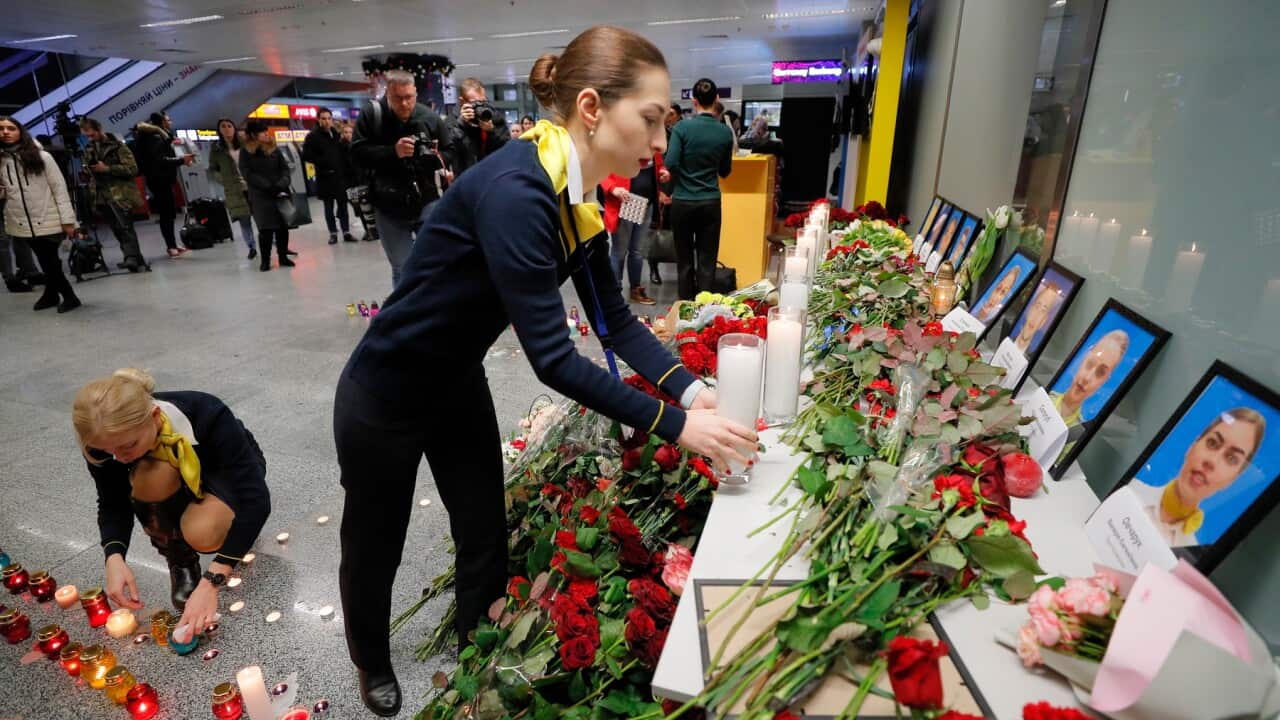Friends and family of crew members of the crashed Ukraine International Airlines Flight lay tributes at the airport in Kiev