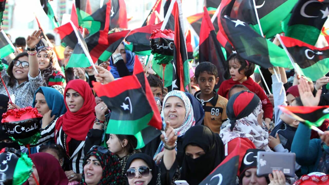 Libyans wave national flags as they celebrate the uprising