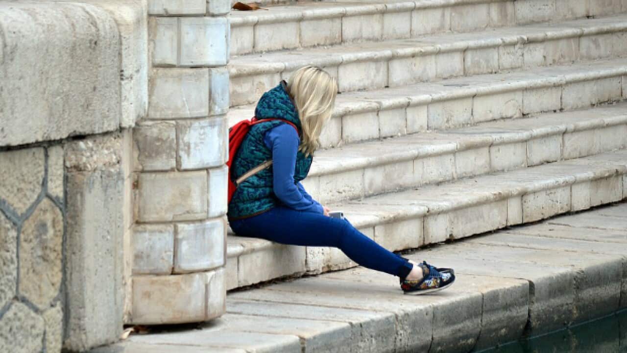 Young woman sitting on steps