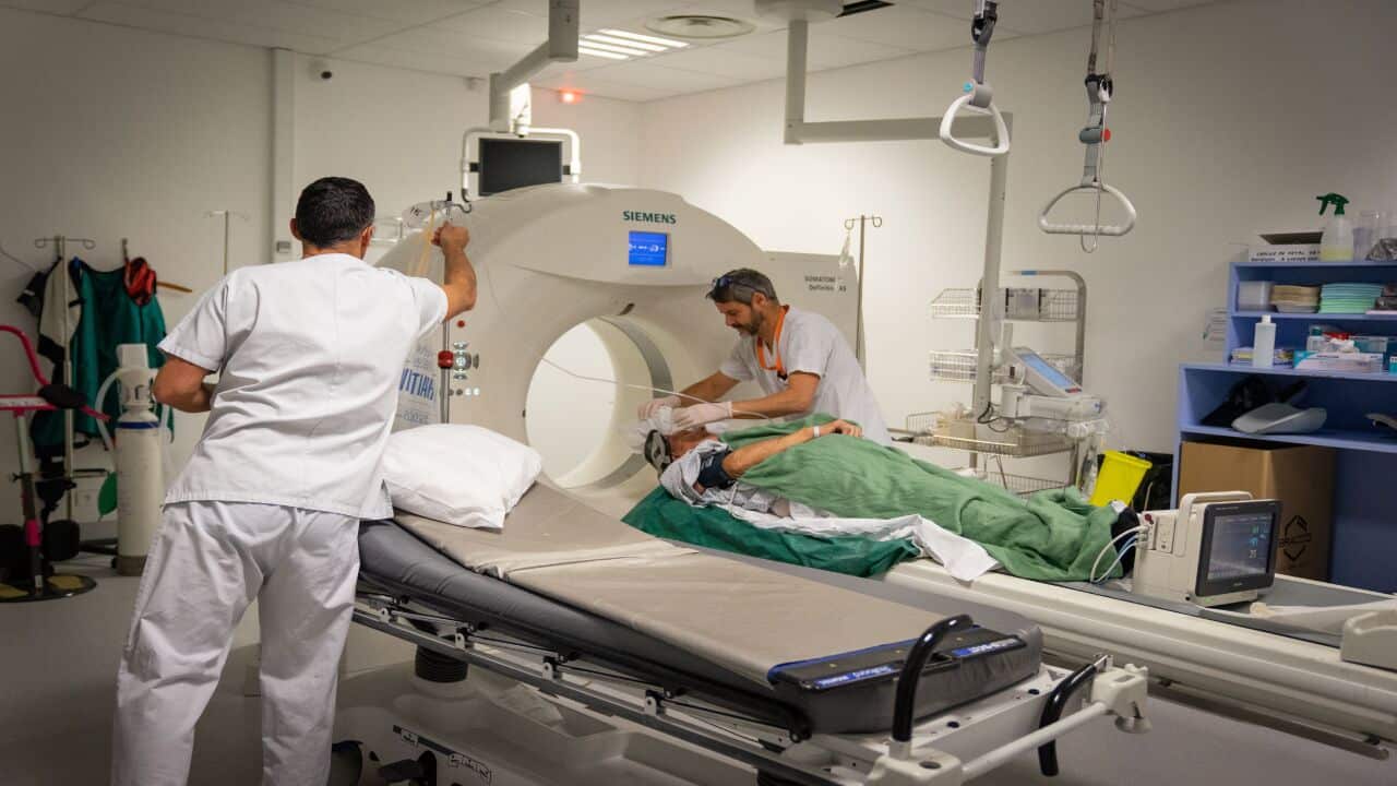 A patient undergoes an injected brain scanner to detect a stroke.