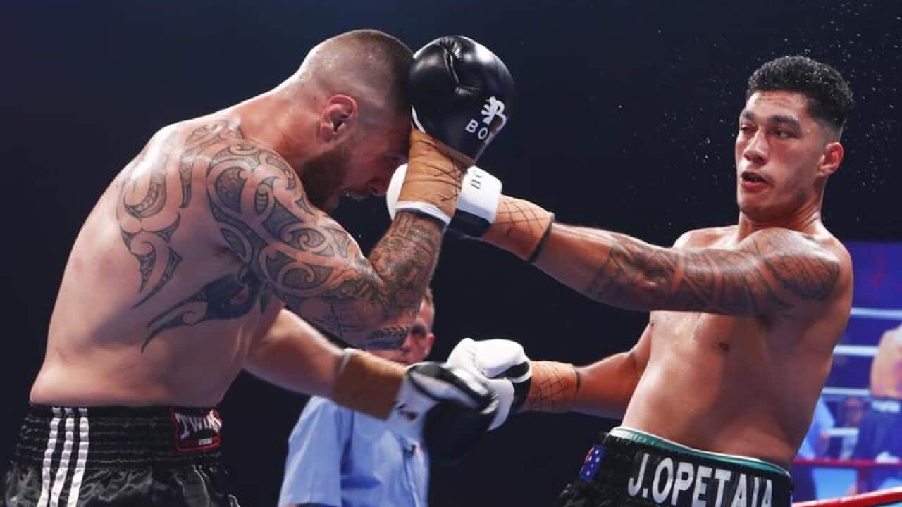 Ben Kelleher (l) fights Jai Opetaia during their bout.