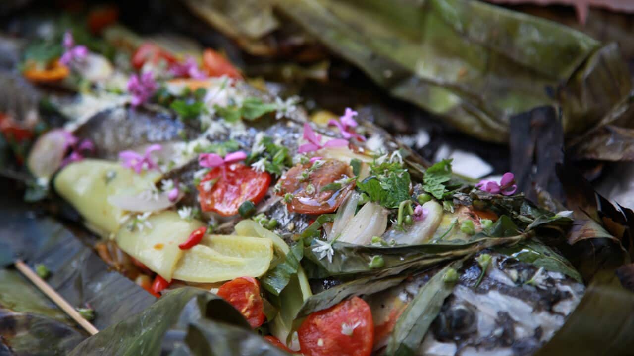Grilled whole flathead in banana leaf