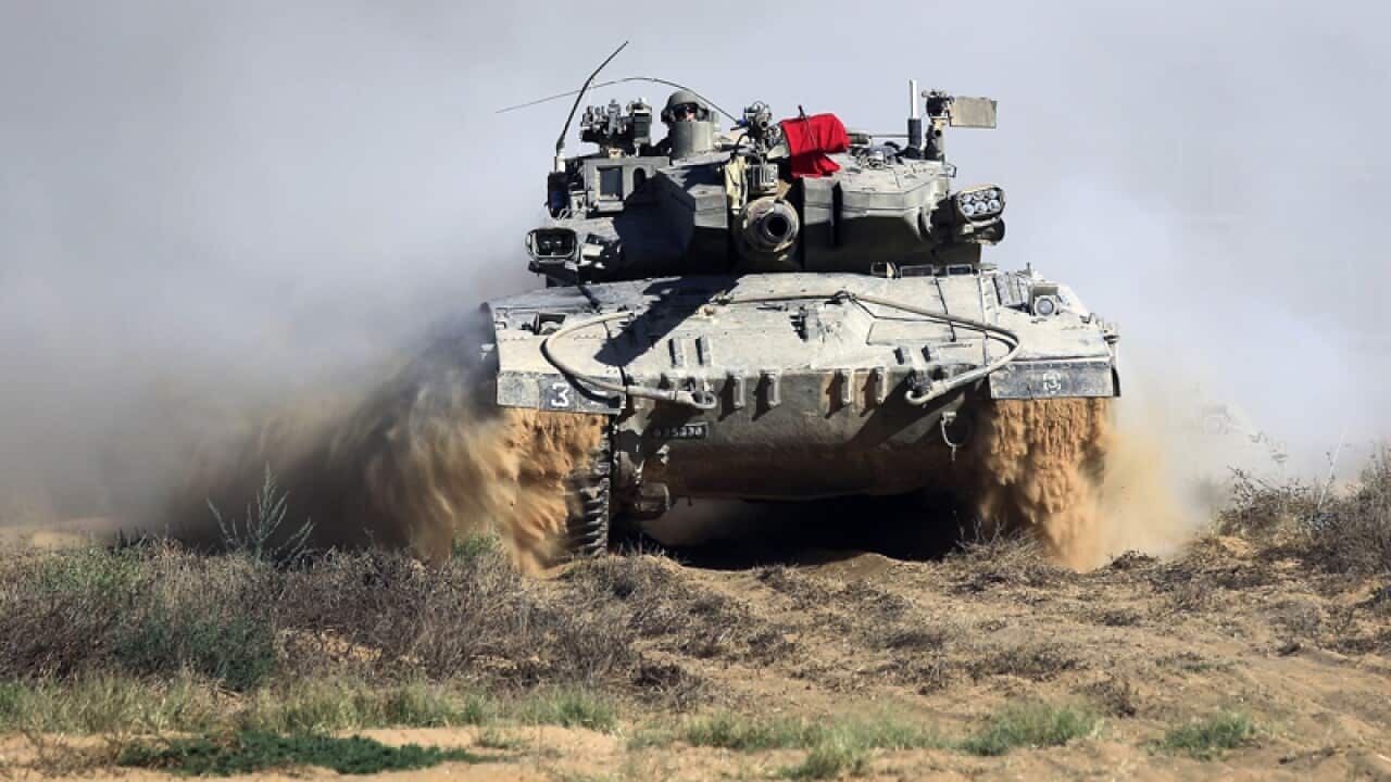 An Israeli tank advances near Gaza.