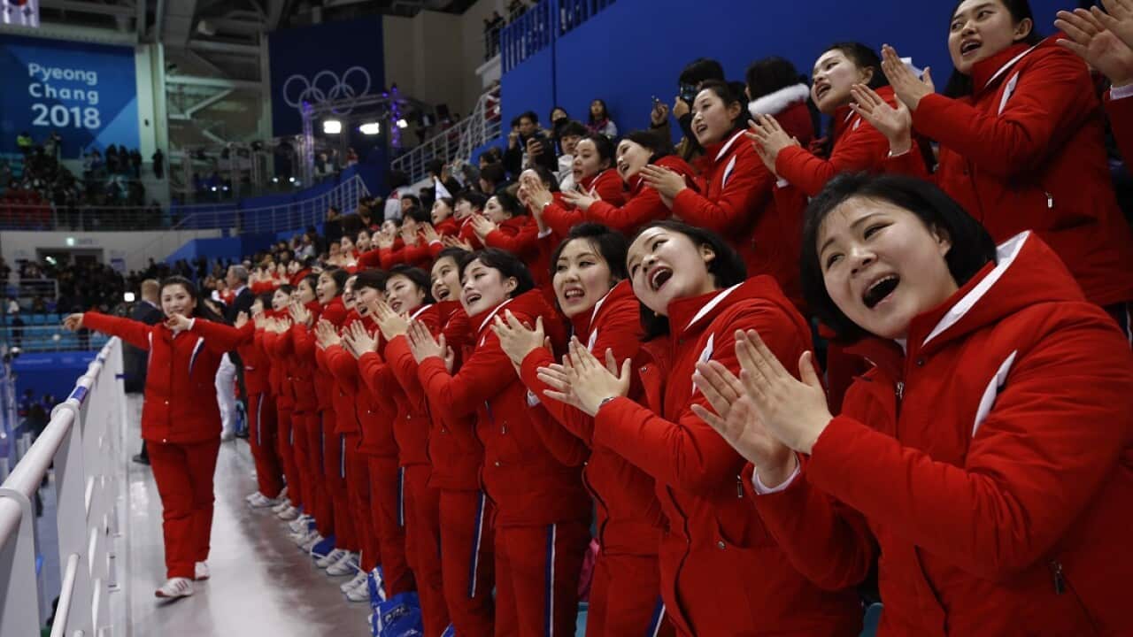 Members of the North Korean cheering group during the preliminary round of the women's hockey game between Switzerland and the combined Koreas.