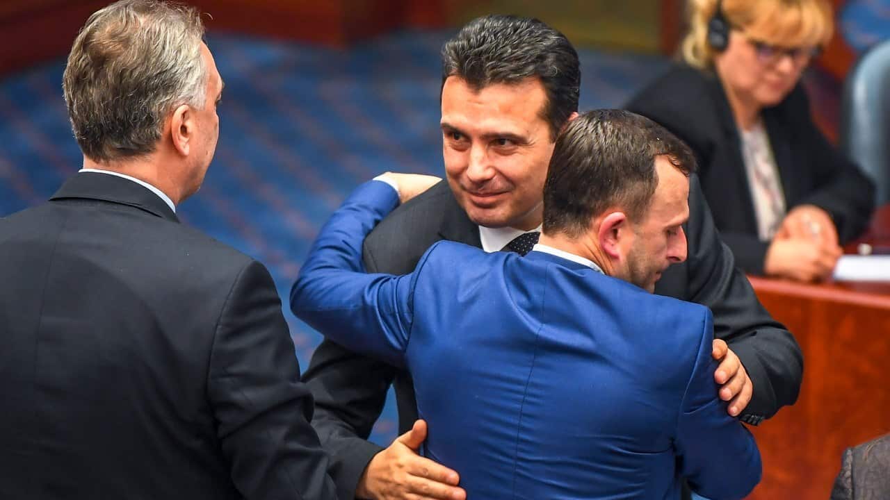 Former Yugoslav Republic of Macedonia PM Zoran Zaev hugs a MP after the Parliament voted to change the country name to North Macedonia.
