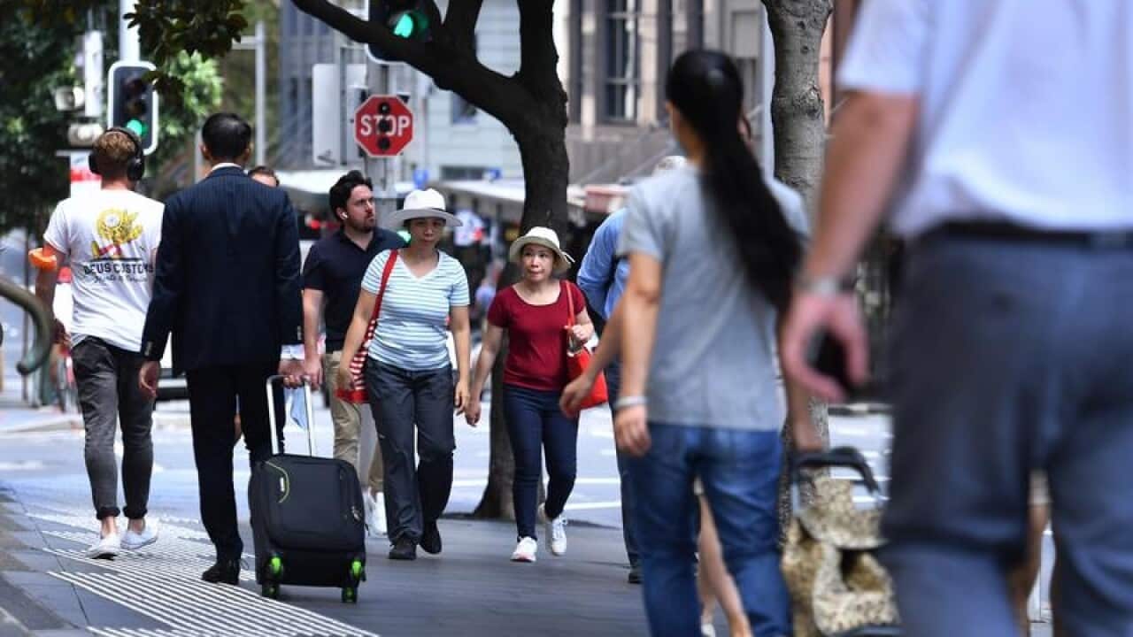 People walk on a Sydney street.