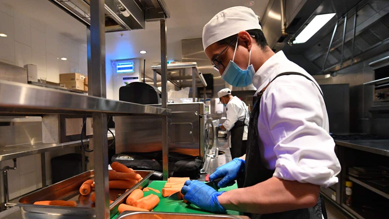 A chef preparing carrots
