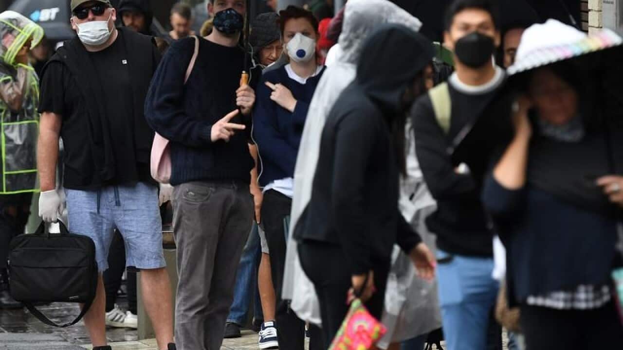 People queue outside a Centrelink in Bondi Junction, Sydney.