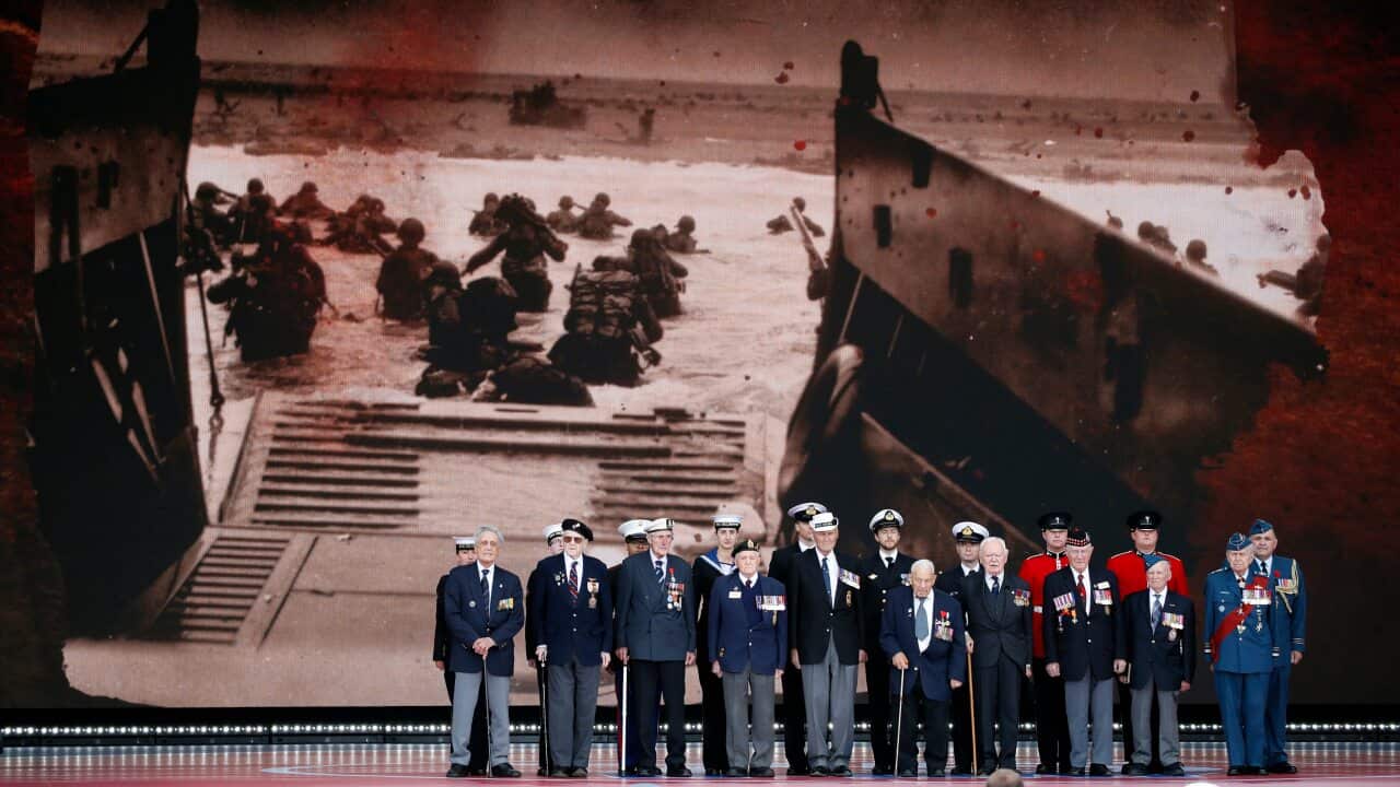Veterans stand on stage during an event to mark the 75th anniversary of D-Day in Portsmouth, England, Wednesday, June 5, 2019. (AP Photo/Alex Brandon)