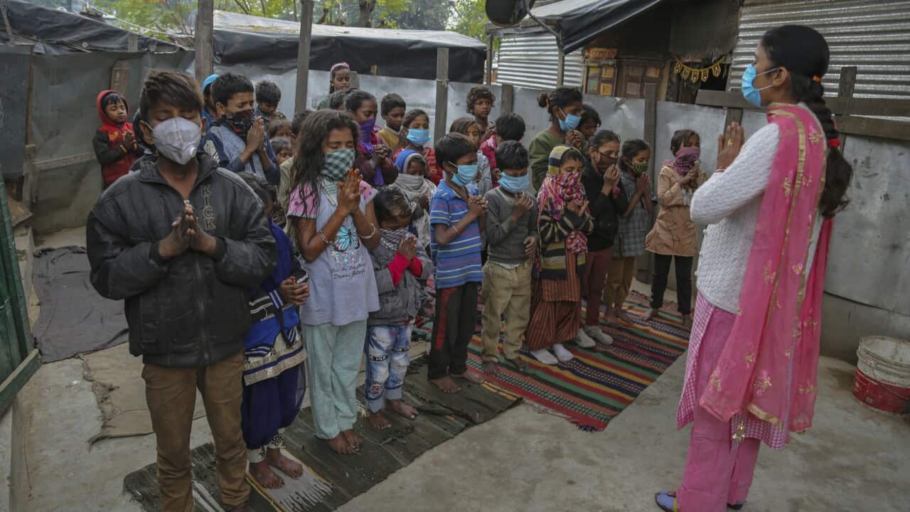 .Underprivileged children wearing face masks attend morning prayerat Sangharsh Vidya Kendra school at Slum area outskirts of Jammu, India