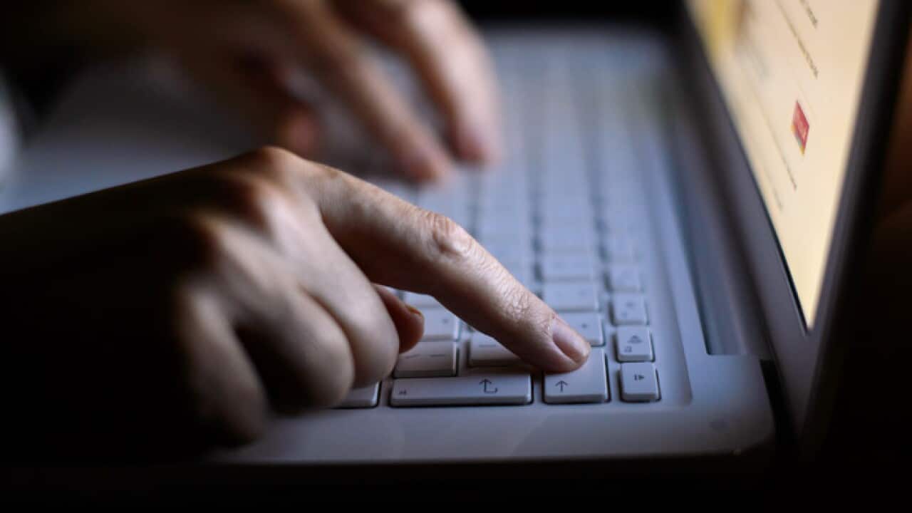 Generic stock photo shows a woman's hands using a laptop keyboard