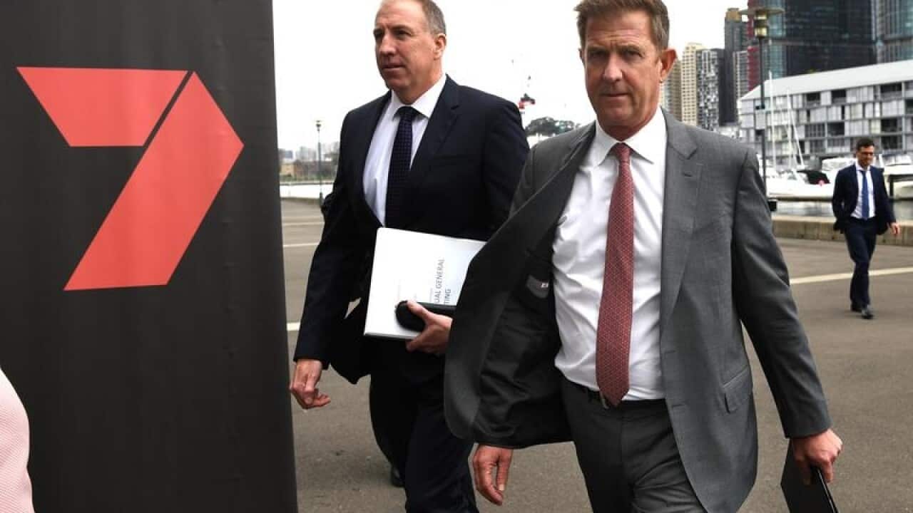 Seven West Media CEO Tim Worner walks past a Seven banner in Sydney.