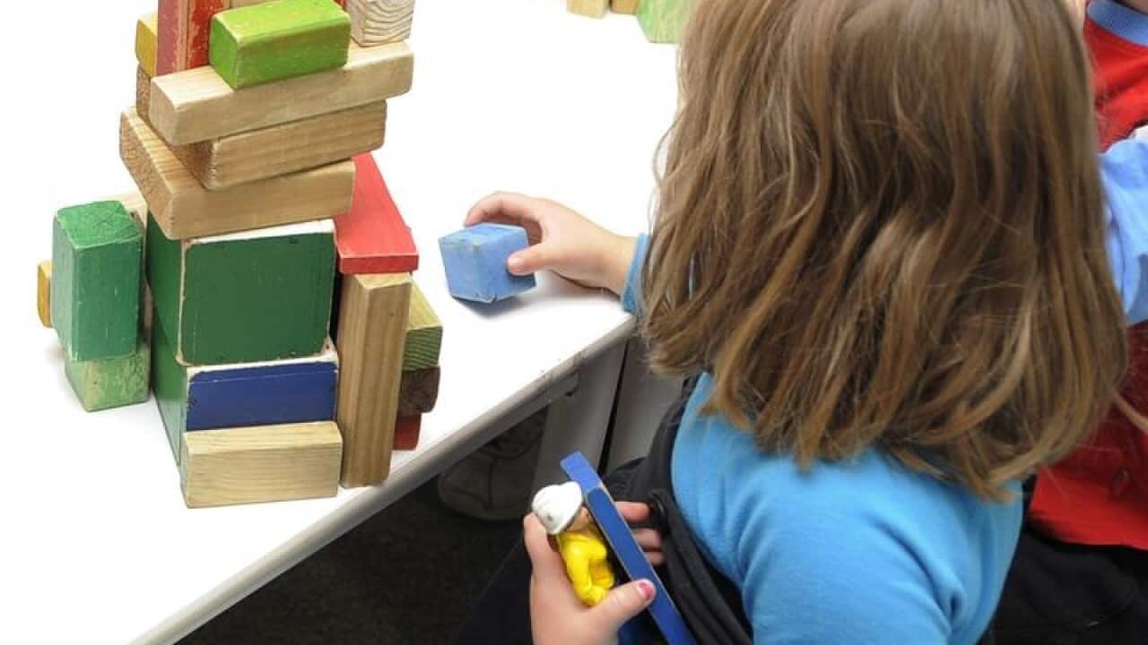 Children play with toys at a preschool in Canberra