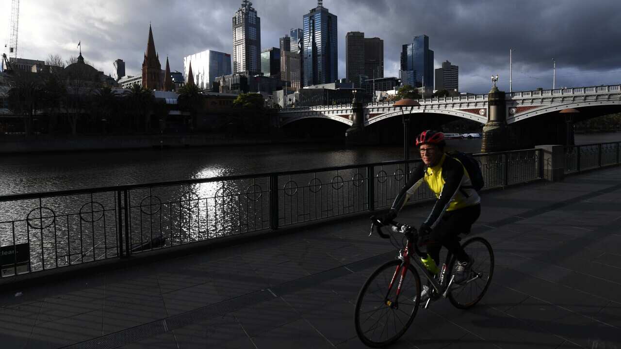 A bike rider is seen along Southbank in Melbourne.