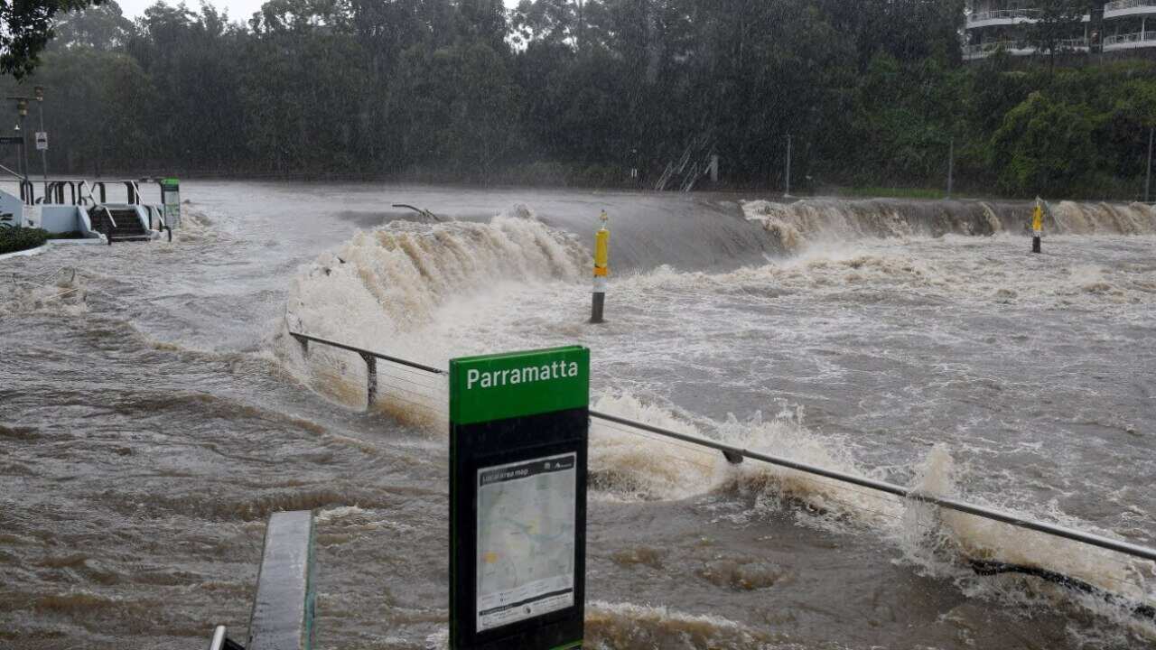 The swollen Parramatta river is seen breaking it’s banks at the Charles St ferry wharf, at Parramatta in Sydney, Saturday, 20 March, 2021.
