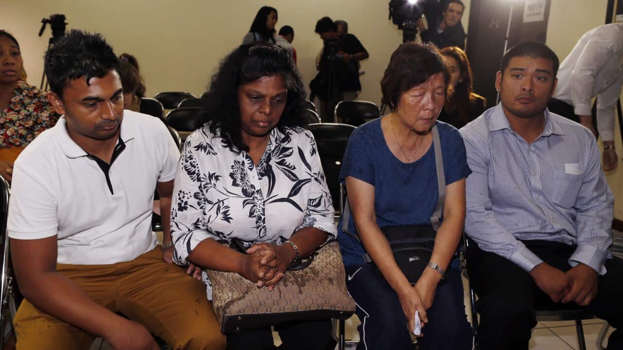 Australian Raji Sukumaran (2-L) the mother of death-row prisoner Myuran Sukumaran, her son Chintu Sukumaran (L), Halen Chan (2-R) the mother of death-row prisoner Andrew Chan, and her son Michael Chan (R) during a visit at the national human rights commis