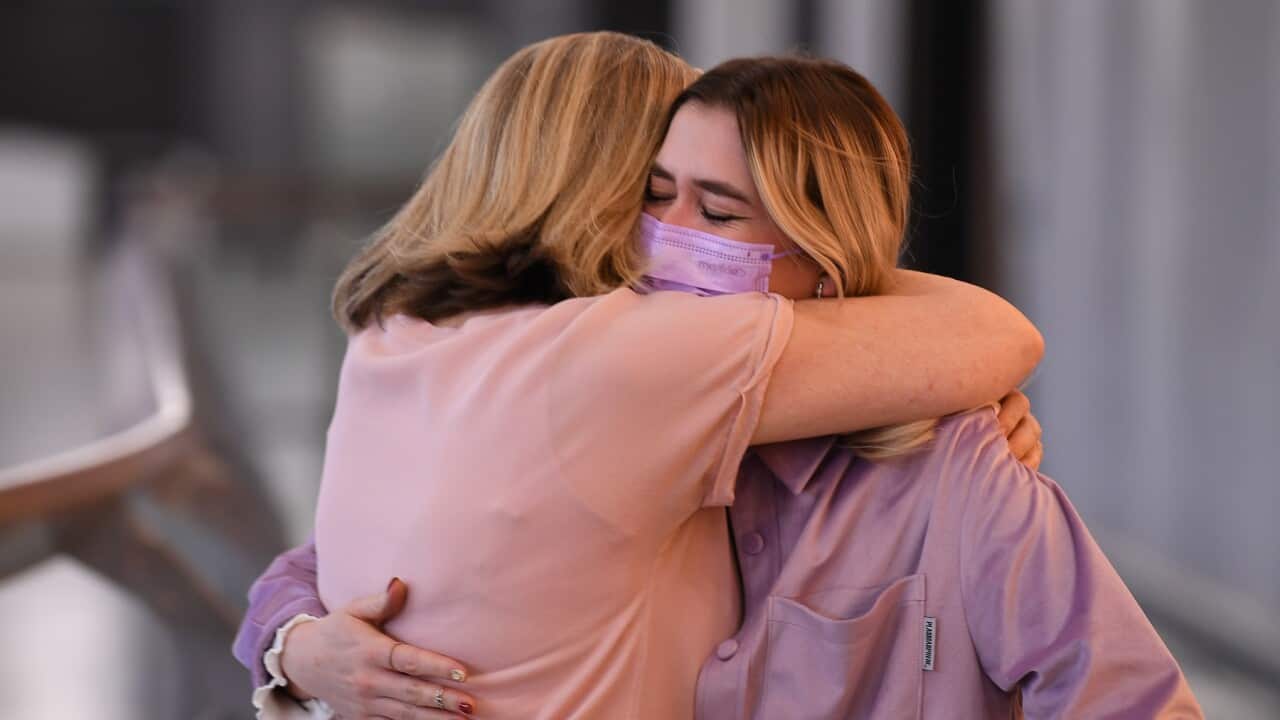 A family is reunited at Tullamarine Airport in Melbourne