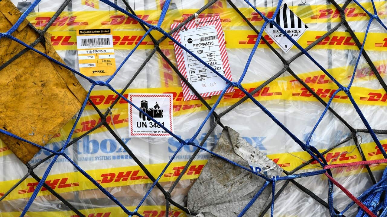 The first Australian shipment of Pfizer COVID-19 vaccines is seen on the tarmac after being unloaded from a Singapore Airlines plane at Sydney International Airport on February 15