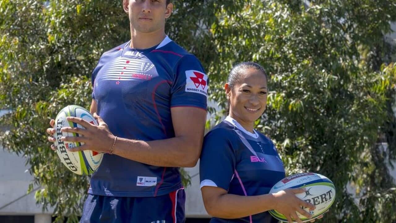 Adam Coleman and Jayne Kareroa pose with footballs.